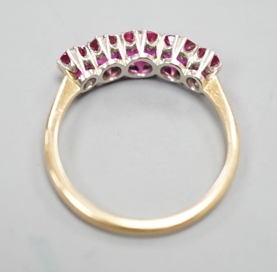 An early 20th century 18ct and plat, graduated five stone ruby set half hoop ring, size Q, gross weight 3.2 grams.